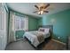 Cozy bedroom with a full-size bed and green walls at 12590 Prince Creek Dr, Parker, CO 80134