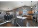 Open concept kitchen with island, wood cabinets, and stainless steel appliances at 12590 Prince Creek Dr, Parker, CO 80134