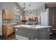 Modern kitchen with wood cabinets, gray countertops, and an island at 12590 Prince Creek Dr, Parker, CO 80134