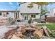 Backyard oasis featuring a tranquil water feature, patio seating, and a hot tub, perfect for unwinding and enjoying the outdoors at 87 Prairie Ridge Rd, Highlands Ranch, CO 80126