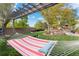 Relaxing backyard getaway with hammock, pergola, beautiful landscaping, and lawn at 87 Prairie Ridge Rd, Highlands Ranch, CO 80126