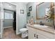 Well-lit bathroom with modern fixtures, granite counters, and convenient laundry area at 87 Prairie Ridge Rd, Highlands Ranch, CO 80126