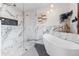 Spa-like bathroom featuring a glass enclosed shower and a modern soaking tub at 87 Prairie Ridge Rd, Highlands Ranch, CO 80126