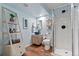 Modern bathroom with a stand-up shower, unique sink, and wood-look floors at 87 Prairie Ridge Rd, Highlands Ranch, CO 80126