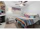 Cozy bedroom with a patterned bedspread, ceiling fan, and comfortable seating at 87 Prairie Ridge Rd, Highlands Ranch, CO 80126