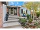 Inviting front entrance with steps leading to a cozy outdoor seating area and mature landscaping at 87 Prairie Ridge Rd, Highlands Ranch, CO 80126