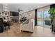 Inviting living room featuring a brick fireplace, built-in bookshelves, and sliding glass doors to the patio at 87 Prairie Ridge Rd, Highlands Ranch, CO 80126