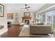 Bright living room featuring a fireplace, hardwood floors, and ample natural light at 87 Prairie Ridge Rd, Highlands Ranch, CO 80126