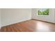 Bright bedroom with wood-look floors and a view of mature trees at 5882 W 109Th Ave, Westminster, CO 80020