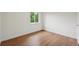 Bright bedroom with hardwood floors, new paint, and large window at 5882 W 109Th Ave, Westminster, CO 80020