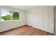 Bright bedroom with wood-look floors and a view of mature trees at 5882 W 109Th Ave, Westminster, CO 80020