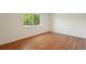 Bright bedroom with wood-look floors and a view of mature trees at 5882 W 109Th Ave, Westminster, CO 80020