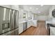 Modern kitchen with stainless steel appliances, white cabinets, and hardwood floors at 5882 W 109Th Ave, Westminster, CO 80020