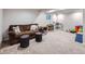Spacious finished basement with plush carpeting and a comfortable seating area with additional room for toys at 12646 Osceola St, Broomfield, CO 80020