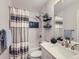 Stylish bathroom with subway tile, decorative accents, and a shower featuring a modern showerhead and tile niche at 12646 Osceola St, Broomfield, CO 80020