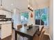 Open concept dining area with a modern light fixture, connects seamlessly to the kitchen and outdoor patio at 12646 Osceola St, Broomfield, CO 80020