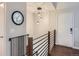 Bright entryway featuring modern lighting, wood-look flooring, and a sleek metal railing at 12646 Osceola St, Broomfield, CO 80020
