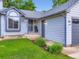 Inviting home exterior with lush green lawn, well-kept landscaping, and stylish gray accents at 12646 Osceola St, Broomfield, CO 80020