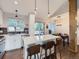 Bright kitchen featuring a quartz countertop island with bar stool seating and adjacent dining area with sliding glass doors at 12646 Osceola St, Broomfield, CO 80020
