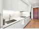 Modern kitchen with sleek white cabinets, quartz countertops, and stainless steel sink, combining style with functionality at 1901 Wazee St # 419, Denver, CO 80202