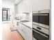 Modern kitchen with sleek white cabinets, stainless steel appliances, and a gas range, ideal for culinary enthusiasts at 1901 Wazee St # 419, Denver, CO 80202