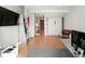 Open-concept living room featuring hardwood floors, built-in shelves, a Murphy bed, and ample natural light, maximizing space and style at 1901 Wazee St # 419, Denver, CO 80202