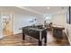 Finished basement with game area, including foosball table and snooker table at 7746 S Gray St, Littleton, CO 80128