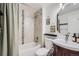 Cozy bathroom featuring tiled shower and tub and a curved vanity at 7746 S Gray St, Littleton, CO 80128