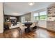 Dining area showcasing hardwood floors, modern decor, and seamless flow into the adjacent kitchen and living spaces at 7746 S Gray St, Littleton, CO 80128