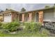 Inviting front exterior with well-manicured landscaping and brick arches at 7746 S Gray St, Littleton, CO 80128