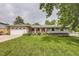 Charming ranch style home with a brick front, well-manicured lawn, and an attached two car garage at 7746 S Gray St, Littleton, CO 80128