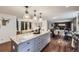 Bright kitchen featuring stainless appliances, granite countertops, hardwood floors, and an expansive center island at 7746 S Gray St, Littleton, CO 80128
