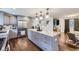 Spacious kitchen boasts granite countertops, stainless steel appliances, a center island, and hardwood floors at 7746 S Gray St, Littleton, CO 80128