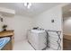 Bright laundry room with washer, dryer, and ample counter space at 7746 S Gray St, Littleton, CO 80128