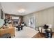 Cozy living room with a brick fireplace, hardwood floors, contemporary furniture, and sliding door access to the patio at 7746 S Gray St, Littleton, CO 80128