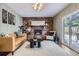 Charming living room featuring a brick fireplace, hardwood floors, a comfortable seating arrangement, and a modern aesthetic at 7746 S Gray St, Littleton, CO 80128