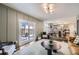 Open-concept living room with hardwood floors, access to a patio, and seamless transition to the kitchen and dining areas at 7746 S Gray St, Littleton, CO 80128