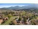 Scenic aerial view of homes surrounded by lush greenery and a distant mountain range, showcasing a peaceful neighborhood at 3620 Silver Plume Ln, Boulder, CO 80305