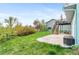 View of the home's backyard with a patio, deck, lush green lawn, and beautiful landscaping at 3620 Silver Plume Ln, Boulder, CO 80305
