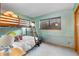 Comfortable bedroom featuring a bunk bed with stuffed animals, window view, and carpet flooring at 3620 Silver Plume Ln, Boulder, CO 80305