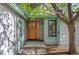Charming front entrance featuring a wood door, stone pathway, and beautiful landscaping at 3620 Silver Plume Ln, Boulder, CO 80305