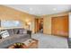Cozy living room featuring a sofa, wood flooring, natural lighting, and closet doors at 3620 Silver Plume Ln, Boulder, CO 80305