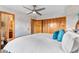 Bright main bedroom featuring a ceiling fan, wood closet doors, and entry to bathroom at 3620 Silver Plume Ln, Boulder, CO 80305