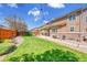 Spacious backyard featuring lush lawn, a paved patio, and a well-maintained wooden fence at 25262 E 2Nd Pl, Aurora, CO 80018