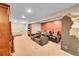 Home theater in the basement with plush leather seating and decorative wall mural at 25262 E 2Nd Pl, Aurora, CO 80018