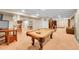 Wide view of a finished basement with pool table, bar area, and entertainment space at 25262 E 2Nd Pl, Aurora, CO 80018