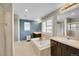 Bright bathroom featuring dual sinks, a soaking tub, and a walk-in shower at 25262 E 2Nd Pl, Aurora, CO 80018