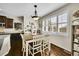 Charming dining area featuring hardwood floors, large windows with plantation shutters and elegant decor at 25262 E 2Nd Pl, Aurora, CO 80018