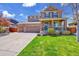 Charming two-story home showcasing a well-manicured lawn and inviting covered porch at 25262 E 2Nd Pl, Aurora, CO 80018