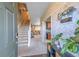 Inviting foyer featuring a staircase, decorative wallpaper, and an open view into the living spaces at 25262 E 2Nd Pl, Aurora, CO 80018